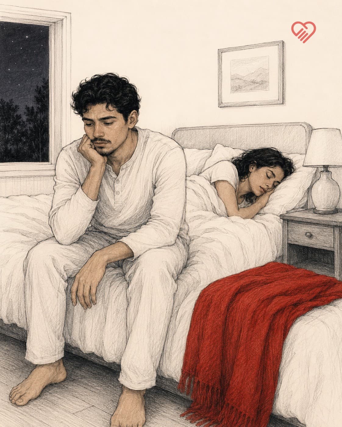 A man sitting awake on the edge of the bed at night, chin resting on his hand, while his partner sleeps behind him and a red blanket lies at the foot of the bed.